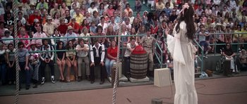 Movie still from “Nashville” (1975), directed by Robert Altman – A crowd of people sitting on the ground watching an event; Wide shot, High angle