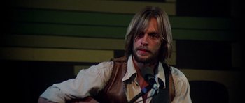 Movie still from “Nashville” (1975), directed by Robert Altman – A man with long blonde hair wearing a brown vest; Close Up shot, Low angle