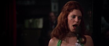 Movie still from “Nashville” (1975), directed by Robert Altman – A woman with red hair is singing into a microphone; Close Up shot, Low angle