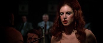 Movie still from “Nashville” (1975), directed by Robert Altman – A beautiful woman with red curly hair standing in front of a microphone; Close Up shot, Low angle