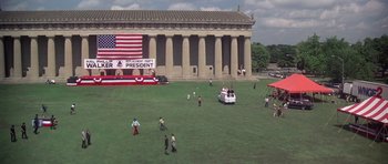 Movie still from “Nashville” (1975), directed by Robert Altman – A group of people standing on top of a lush green field; Extreme Wide shot, High angle