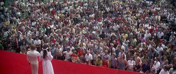 Movie still from “Nashville” (1975), directed by Robert Altman – A large crowd of people gathered together in a stadium; Extreme Wide shot, High angle