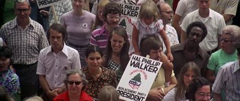 Movie still from “Nashville” (1975), directed by Robert Altman – A group of people standing in a crowd holding signs; Medium shot, High angle