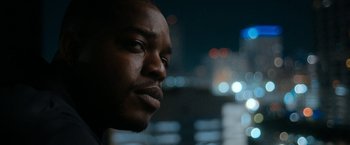 Movie still from “National Champions” (2021), directed by Ric Roman Waugh – A man's face at night; Close Up shot, Low angle