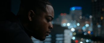 Movie still from “National Champions” (2021), directed by Ric Roman Waugh – A man's face at night; Close Up shot, Low angle