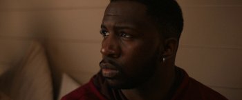Movie still from “National Champions” (2021), directed by Ric Roman Waugh – A person looking at the camera; Close Up shot, Over the shoulder angle