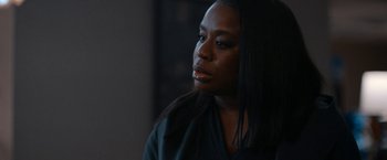 Movie still from “National Champions” (2021), directed by Ric Roman Waugh – A person with long black hair; Close Up shot, Over the shoulder angle