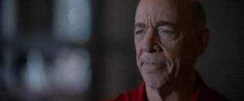 Movie still from “National Champions” (2021), directed by Ric Roman Waugh – An older man is looking at the camera; Close Up shot, Over the shoulder angle