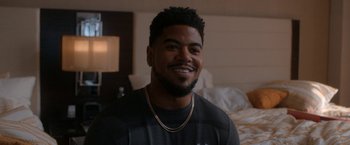 Movie still from “National Champions” (2021), directed by Ric Roman Waugh – A person wearing a necklace; Close Up shot, Over the shoulder angle