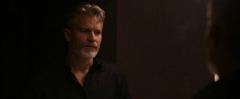 Movie still from “National Champions” (2021), directed by Ric Roman Waugh – A person wearing a black shirt; Close Up shot, Over the shoulder angle