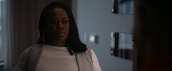 Movie still from “National Champions” (2021), directed by Ric Roman Waugh – A woman with long black hair standing in front of a mirror; Close Up shot, Over the shoulder angle