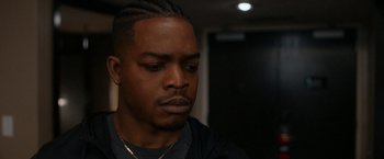 Movie still from “National Champions” (2021), directed by Ric Roman Waugh – A person wearing a black shirt; Close Up shot, Over the shoulder angle