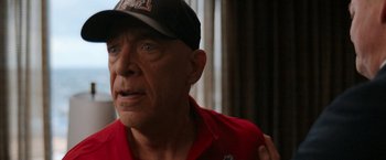 Movie still from “National Champions” (2021), directed by Ric Roman Waugh – An older man wearing a baseball cap and a red shirt; Close Up shot, Over the shoulder angle