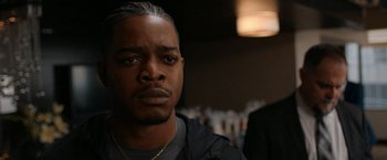 Movie still from “National Champions” (2021), directed by Ric Roman Waugh – A person wearing a jacket; Close Up shot, Over the shoulder angle