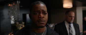 Movie still from “National Champions” (2021), directed by Ric Roman Waugh – A person wearing a black shirt; Close Up shot, Over the shoulder angle