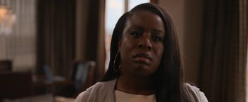 Movie still from “National Champions” (2021), directed by Ric Roman Waugh – A person with long black hair; Close Up shot, Over the shoulder angle