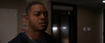 Movie still from “National Champions” (2021), directed by Ric Roman Waugh – A person wearing a black shirt; Close Up shot, Over the shoulder angle