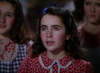 Movie still from “National Velvet” (1944), directed by Clarence Brown – A young girl in a red polka dot dress; Close Up shot, High angle