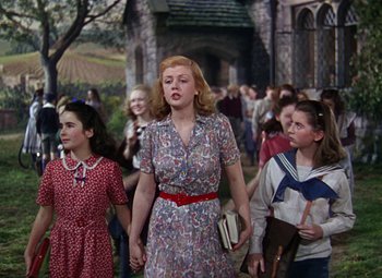 Movie still from “National Velvet” (1944), directed by Clarence Brown – A group of young people walking down a sidewalk; Medium shot, Low angle