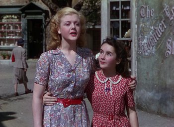 Movie still from “National Velvet” (1944), directed by Clarence Brown – Two young women standing next to each other on the street; Medium shot, Low angle