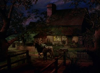 Movie still from “National Velvet” (1944), directed by Clarence Brown – A man on a horse in front of a house at night; Extreme Wide shot, High angle
