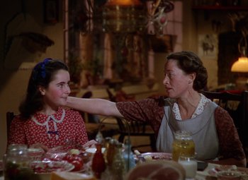 Movie still from “National Velvet” (1944), directed by Clarence Brown – Two women sitting at a table with food on the table; Medium shot, Over the shoulder angle