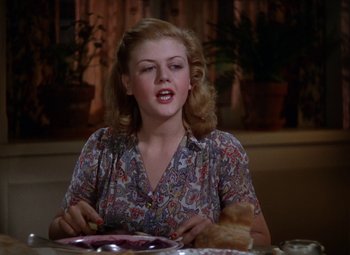 Movie still from “National Velvet” (1944), directed by Clarence Brown – A woman sitting at a table with a plate in front of her; Close Up shot, Over the shoulder angle