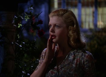 Movie still from “National Velvet” (1944), directed by Clarence Brown – A beautiful blonde woman in a floral print dress; Close Up shot, Low angle
