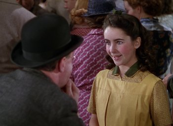 Movie still from “National Velvet” (1944), directed by Clarence Brown – An older man talking to a young girl in front of a crowd; Close Up shot, Over the shoulder angle