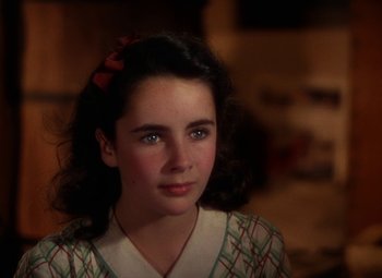 Movie still from “National Velvet” (1944), directed by Clarence Brown – A young girl is looking into the camera; Close Up shot, High angle