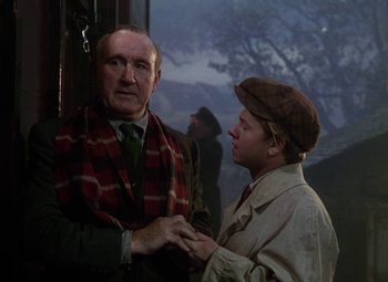 Movie still from “National Velvet” (1944), directed by Clarence Brown – A man and a man standing next to each other in front of a window; Medium shot, Over the shoulder angle