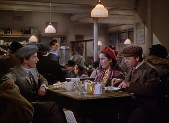 Movie still from “National Velvet” (1944), directed by Clarence Brown – A group of people sitting at a table in a restaurant; Medium shot, High angle