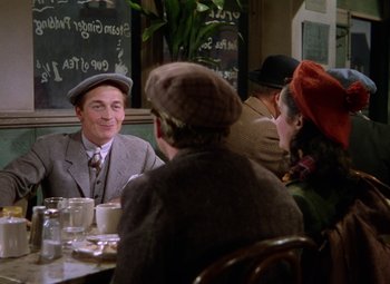 Movie still from “National Velvet” (1944), directed by Clarence Brown – A group of people sitting around a table; Medium shot, High angle