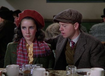 Movie still from “National Velvet” (1944), directed by Clarence Brown – A man and a woman sitting at a dinner table; Medium shot, Over the shoulder angle