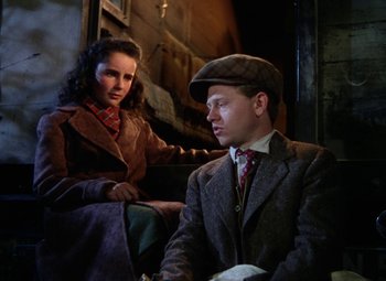 Movie still from “National Velvet” (1944), directed by Clarence Brown – A man and a woman sitting next to each other on a bench; Medium shot, High angle