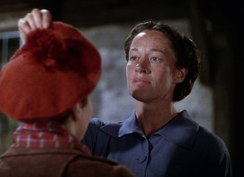 Movie still from “National Velvet” (1944), directed by Clarence Brown – A woman is looking at a man in a red hat; Close Up shot, Low angle