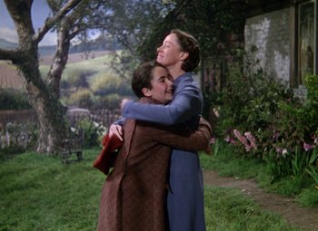 Movie still from “National Velvet” (1944), directed by Clarence Brown – Two people hugging each other in a field; Medium shot, Low angle