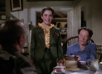 Movie still from “National Velvet” (1944), directed by Clarence Brown – A woman standing in front of a table with a tea pot on top of it; Medium shot, High angle