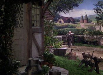 Movie still from “National Velvet” (1944), directed by Clarence Brown – A painting of an old man walking in a yard with a dog; Extreme Wide shot, High angle