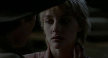 Movie still from “Near Dark” (1987), directed by Kathryn Bigelow – A woman looking at a man in a black hat; Close Up shot, Over the shoulder angle