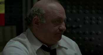 Movie still from “Near Dark” (1987), directed by Kathryn Bigelow – An older man wearing a white shirt and a black tie; Close Up shot, Low angle