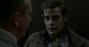 Movie still from “Near Dark” (1987), directed by Kathryn Bigelow – A man in a brown jacket looking at another man in a brown jacket; Close Up shot, Over the shoulder angle