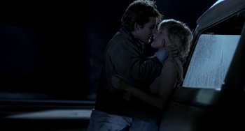 Movie still from “Near Dark” (1987), directed by Kathryn Bigelow – A man and a woman kissing in the dark; Medium shot, Low angle
