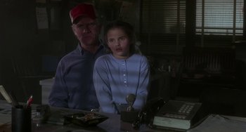 Movie still from “Near Dark” (1987), directed by Kathryn Bigelow – A man and a woman standing next to each other in a room; Medium shot, High angle