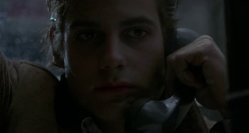 Movie still from “Near Dark” (1987), directed by Kathryn Bigelow – A person wearing a headset; Close Up shot, Low angle