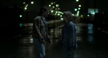 Movie still from “Near Dark” (1987), directed by Kathryn Bigelow – Two people standing in the street at night talking to each other; Medium shot, Over the shoulder angle