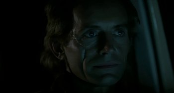 Movie still from “Near Dark” (1987), directed by Kathryn Bigelow – The face of a man in a dimly - lit room; Close Up shot, Low angle