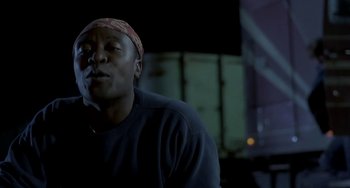 Movie still from “Near Dark” (1987), directed by Kathryn Bigelow – A man with a bandanna on his head is standing in the dark; Close Up shot, Low angle