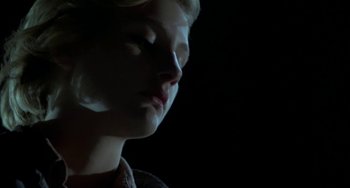 Movie still from “Near Dark” (1987), directed by Kathryn Bigelow – A young woman is looking down at her face; Close Up shot, Low angle