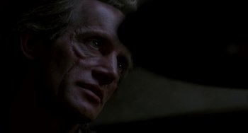 Movie still from “Near Dark” (1987), directed by Kathryn Bigelow – A person's face in the dark; Close Up shot, Low angle